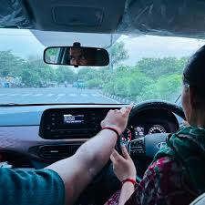 Rashi Motor Driving School learner practising car driving on a Jaipur road
